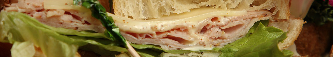 Eating Deli Sandwich at Sunac Fancy Food restaurant in New York, NY.